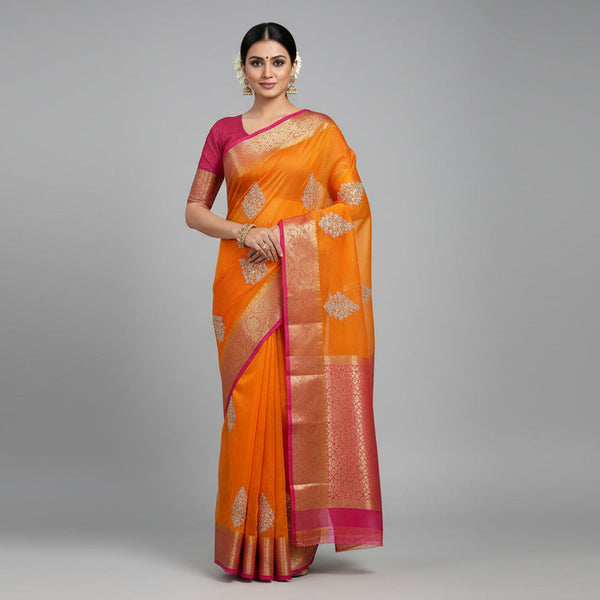 Orange saree with silver embroidery and a pink blouse.