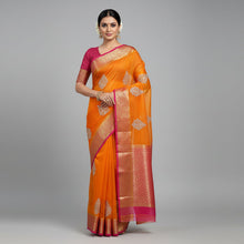 Orange saree with silver embroidery and a pink blouse.