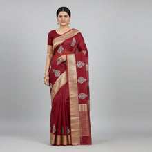 Red saree with floral patterns and a Buddha statue on a red background
